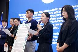 A group of people standing in front of a blue wall

AI-generated content may be incorrect.