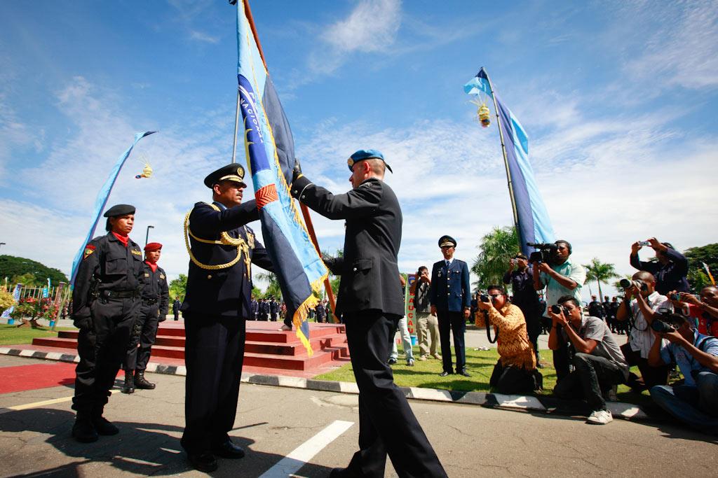 UN Police Commissioner Luís Carrilho hands over the flag of the Timorese police to the General Commander of PNTL, Longuinhos Monteiro to commemorate the resumption of primary policing responsibility by PNTL at the Government Palace in Dili