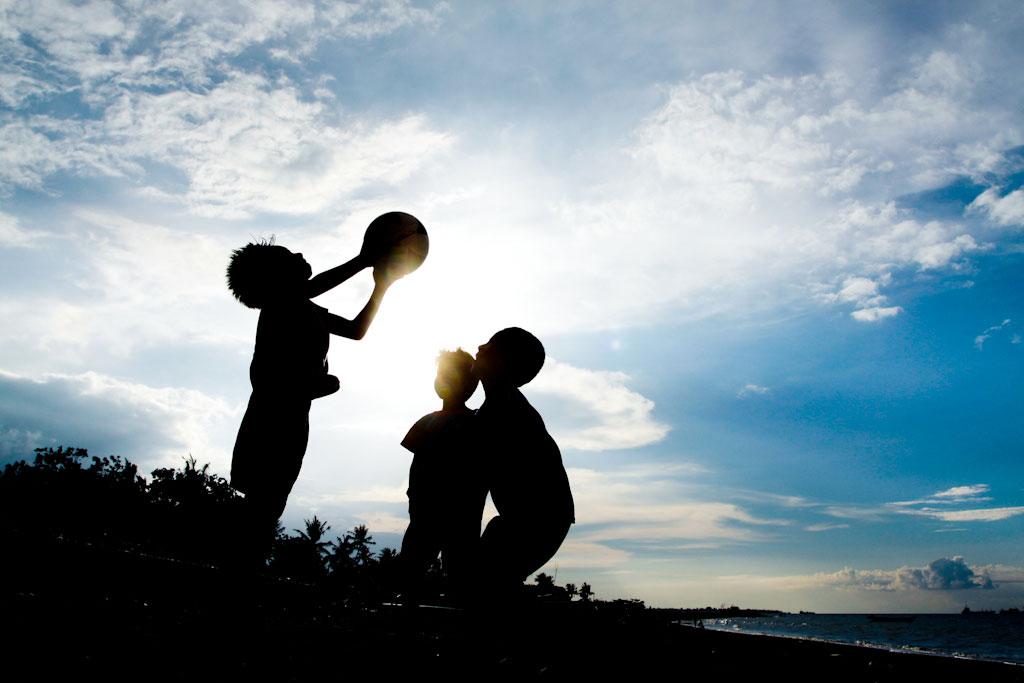 Children play football at Bidau Santana in Dili
