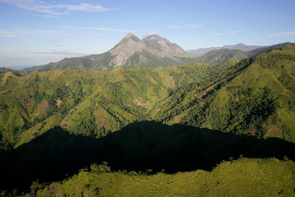 Lush green mountains against a clear blue sky