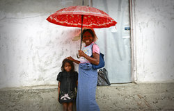 A mother from Gleno, in Ermera, walks to a local market with her daughter. Photo by UNMIT/Martine Pe